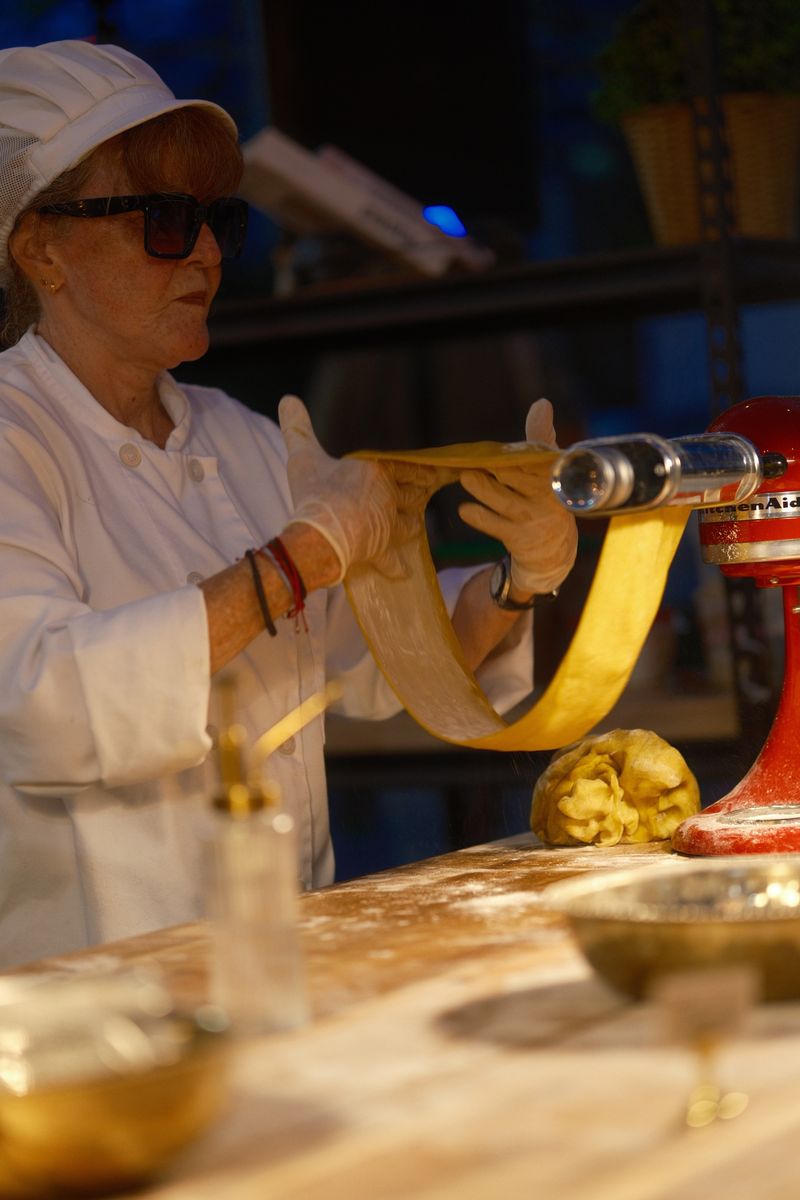 Chef serving pasta at a food station
